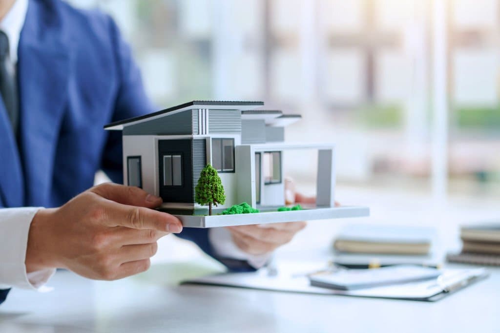L’agent immobilier offre la conception de la maison et le contrat.